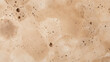 Closeup of warm beige travertine with s of deep pitted holes that resemble patterns found in nature. This type of travertine is known for its earthy and organic look, making it ideal for