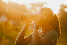 Woman Looking Through Binoculars At The Nature Of Brazil. Beautiful Sunset View Of The Pantanal, Bonito, In Mato Grosso Do Sul.
