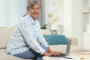 Sticker - Beautiful senior woman using laptop at home, space for text