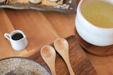 Fototapeta Mapy - Wooden spoon with japanese green tea on table cafe. Tableware wood set concept. 