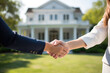 A female real estate agent and a female client or woman shaking hands in front of new home