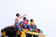 © SHUTTER DIN - teenager girl friends group sitting on the roof of yellow a minibus, chiamg mai thailand, amazing travel tourist concept,