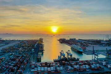 Business logistic import-export transport international and transportation of containers ships at seaport , Shipping container buildings, roads at sunset evening view of Shipping containers.