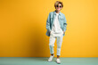 © Patcharaphon - Fashionable young man posing in studio over yellow background. Copy space. Generative Ai