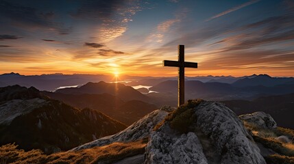 Christian cross on the top of a mountain at susnet.