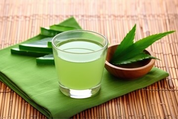 Sticker - a view of aloe juice and cut leaves arranged on a woven placemat