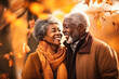 © Anoo - An elderly dark-skinned couple, a man and a woman, hugging in an autumn park. They look at each other with a loving gaze. Seniors dating. Relationships in old age. Love and romance.