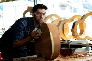 Wall Mural - Luthier Sanding Acoustic Guitar Body in Workshop