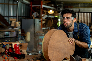 Wall Mural - Luthier Sanding Acoustic Guitar Body in Workshop