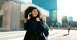 © N F/peopleimages.com - Walking, city or happy businesswoman on a phone call talking, networking or speaking in travel. Mobile communication, chat or biracial female entrepreneur in conversation, discussion or negotiation