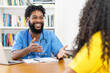 © Daniel Ernst - Laughing african american male nurse talking with female patient