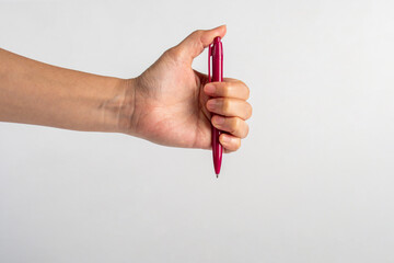 Hand holding pen isolated on white background