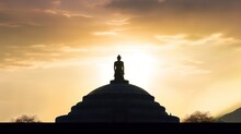 Silhouette Of Buddha Statue In Temple With Sunset Background