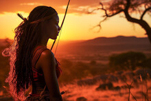 Stirring Silhouette Of A Skillful Indigenous African Woman Hunting With Bow And Arrow In Sweeping Grassland Under Stormy Sky.