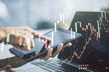 Poster - Multi exposure of abstract financial graph with world map and hand working with a digital tablet on background, financial and trading concept