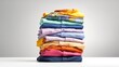 © _veiksme_ - Neatly Folded Colorful Shirts Stacked in Gradual Order