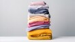 © _veiksme_ - Neatly Folded Colorful Shirts Stacked in Gradual Order