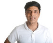 A smart middle-aged fit Indian man in a white t-shirt - studio shot
