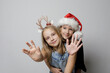 © millaf - Beautiful Christmas girl best friends sisters on white background, Christmas studio portrait