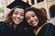 Portrait of two smiling female graduate students posing for a shot