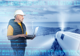 Man is wind energy specialist. Fragment windmill near guy. Engineer with laptop works at power plant. Offshore wind turbines. Man adjusts windmills via computer. Green energy. Wind turbines spinning