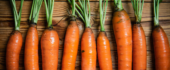 Poster - Fresh carrots on wooden table.