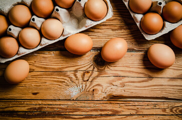 Wall Mural - Chicken eggs on wooden table.