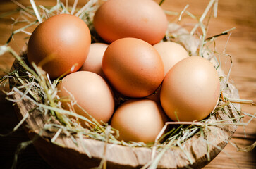 Wall Mural - Chicken eggs in a plate on wooden table.