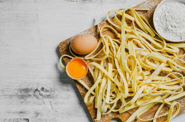 Poster - Homemade pasta tagliatelle. On white table.