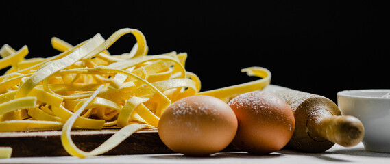 Wall Mural - Homemade pasta tagliatelle. On white table.