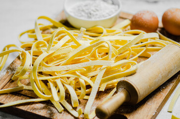 Sticker - Homemade pasta tagliatelle. On white table.