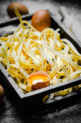 Sticker - Homemade pasta tagliatelle. On black table.