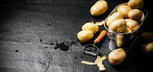 Wall Mural - Fresh potatoes. On black background.