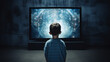 Back view of a boy child head in front of a huge tv screen representing too much children screen time