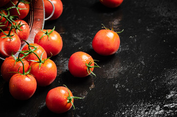 Canvas Print - Fresh tomatoes. On black table.