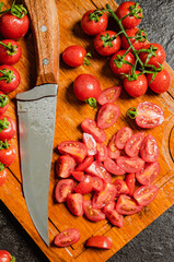 Wall Mural - Fresh chopped tomatoes. On black table.
