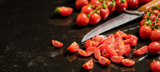Wall Mural - Fresh chopped tomatoes. On black table.