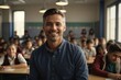 Portrait of happy male teacher in an elementary school classroom. He's smiling and looking at the camera while students are learning in the background.