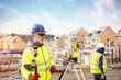 © Iryna - Surveyor builder site engineer with theodolite total station at construction site outdoors during surveying work