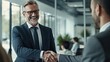 © Malynka - Smiling middle aged business man handshaking partner making partnership collaboration agreement at office meeting, hr manager, new worker shake hands recruiting at job interview. Welcome onboarding
