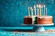 Colorful birthday cake with sprinkles and ten candles on a blue background with copyspace