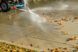 Watering streets and sidewalks using special equipment to wash away dust and leaves