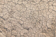 Top view of abstract, cracked, brown earth resembling the surface of Mars or the moon, a textured topography portraying the beauty of desolation