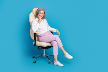 Sticker - Full length photo of positive thoughtful woman dressed white shirt eyewear sitting chair empty space isolated blue color background