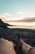 © ADDICTIVE STOCK - Crop legs of woman relaxing on wet sandy beach