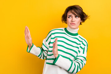 Canvas Print - Photo of young girl skeptical suspicious look empty space dislike your proposition try drugs arms stop isolated on yellow color background