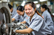 Asian Woman in Factory Looks at the Camera and Smiles