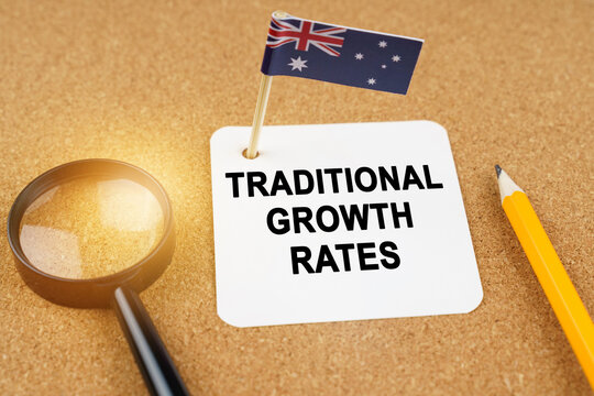On the table is the flag of Australia and a sheet of paper with the inscription - traditional growth rates