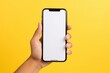 Closeup hand holding mobile phone mockup in yellow plain background