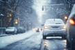 Driving car on slippery snowy street in city. Road traffic and accidents at winter season